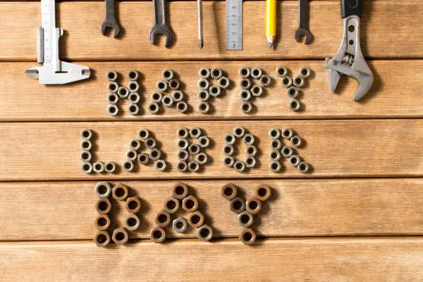 Labor day.  Different tools on a wooden table