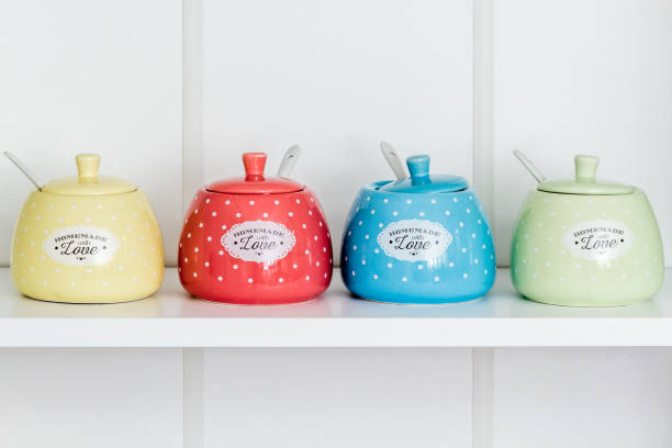 istock Colorful Sugar Bowls in a White Shelf 942519678