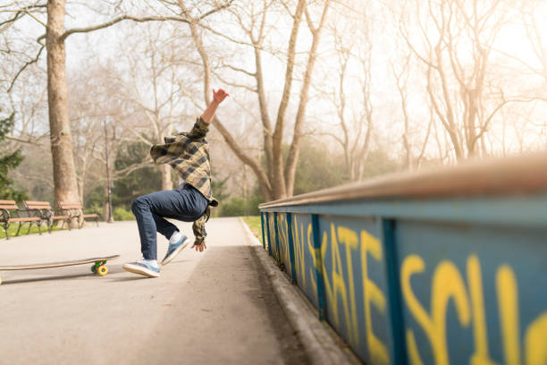 Teenage skater falling stock photo
