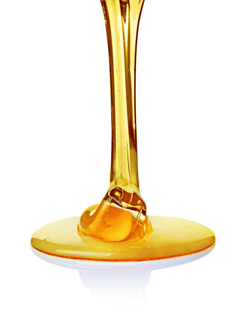 istock Pouring natural transparent honey 942519920