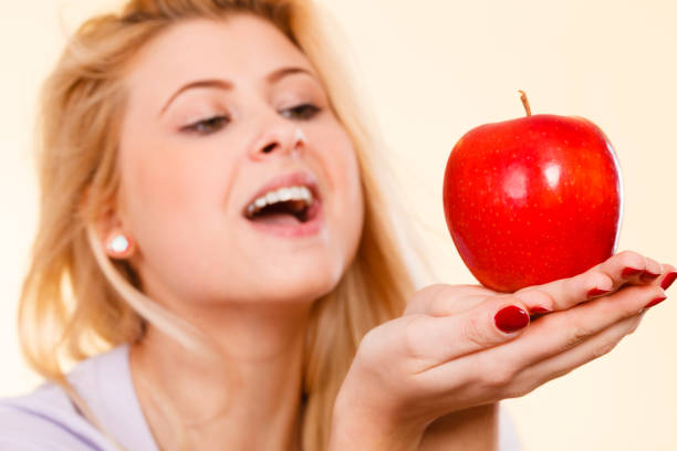 istock Happy woman holding delicious red apple 942522732