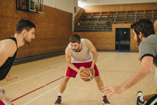 istock Young basketball player dribbling his opponents during the match. 942522804