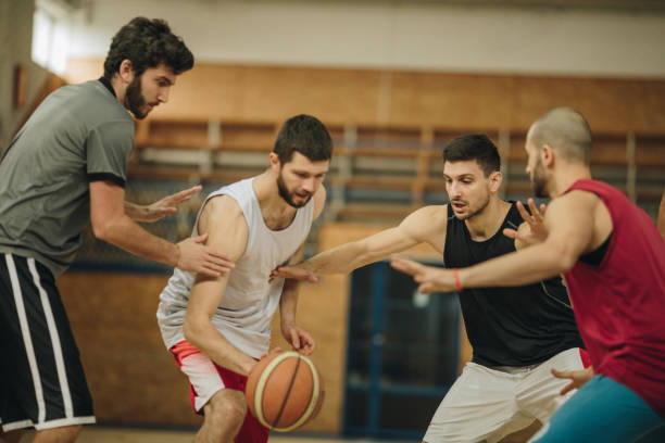 istock Basketball player trying to get through defensive players. 942525744
