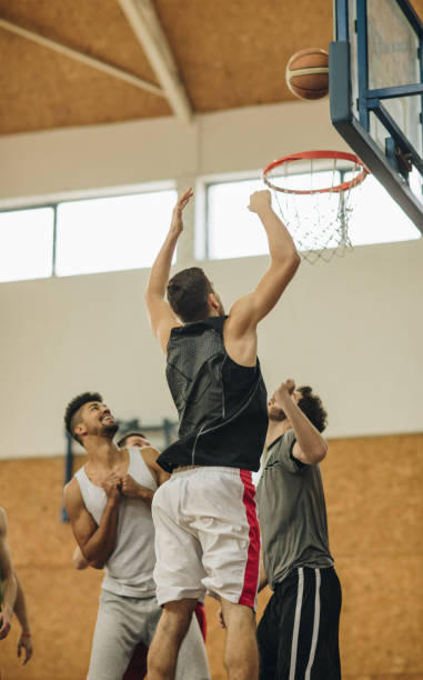 istock Group of young athletic men playing basketball. 942525916
