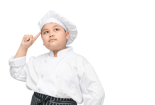 kid chef is thinking new menu. asian boy chef thinking isolated on white background with clipping path