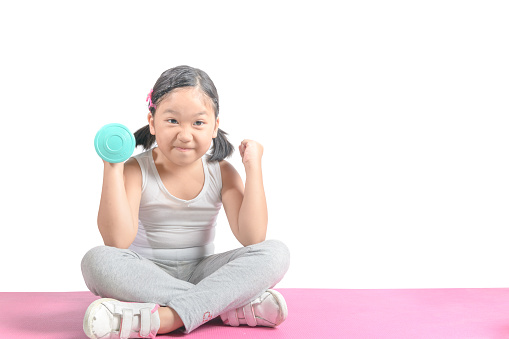 cute asian girl holding dumbbell isolated on white background, diet and exercise for good health concept