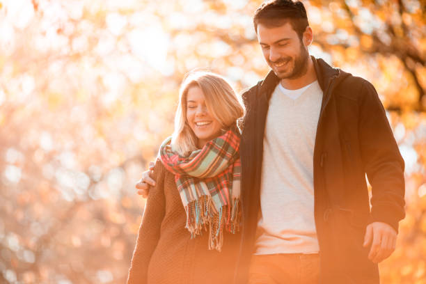 istock Happy embraced couple taking an autumn walk in nature. 942527310