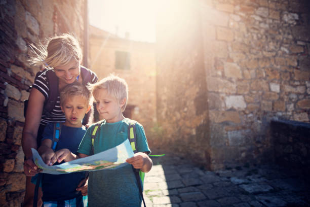 istock Mother and sons sightseeing small Italian town 942538424