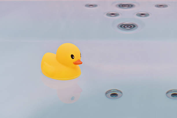istock Large yellow rubber duck floating in bathtub 942546380
