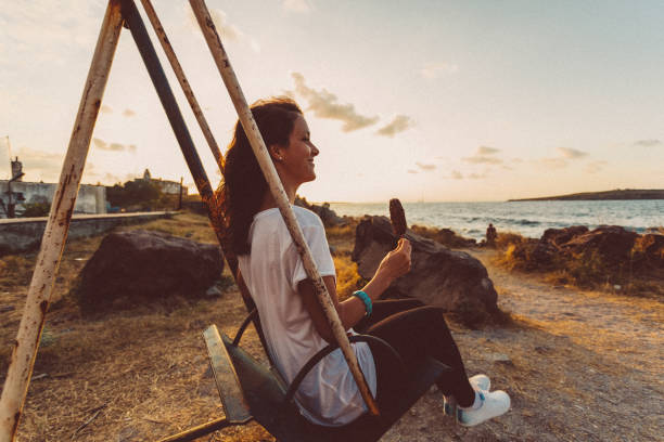 istock Woman swinging on sunset 942547362