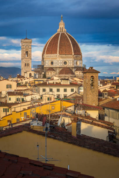 The Cattedrale di Santa Maria del Fiore dome in sunrise The Cattedrale di Santa Maria del Fiore dome in sunrise warm light. Next bell tower with beautiful mosaic ornamentation. michelangelo italy art david stock pictures, royalty-free photos & images