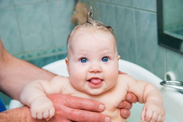 istock Bathing funny baby in the tub. 942552622