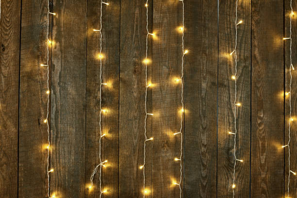 istock dark wood background with lights, abstract holiday backdrop, copy space for text 942559282