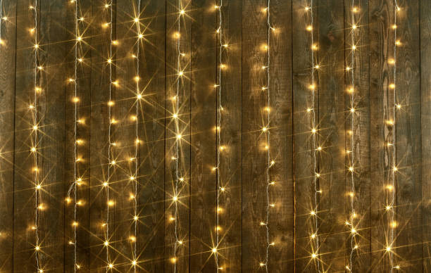 istock dark wood background with lights, abstract holiday backdrop, copy space for text 942559486