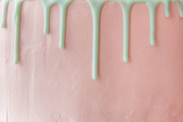 The front side of the pink cake with cream drips. Copy space