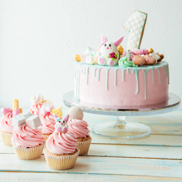 Cupcakes and pink birthday cake one year old