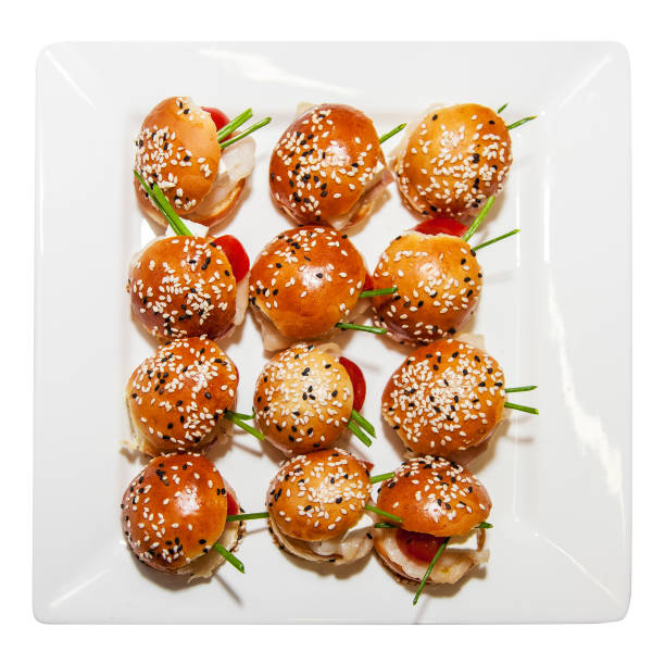 Mini burgers with cheese and tomatoes, appetizer on white background, Delicious and healthy restaurant meals, closeup