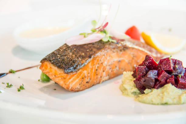 istock Tasty grilled salmon steak on mixed colorful vegetables 942564416