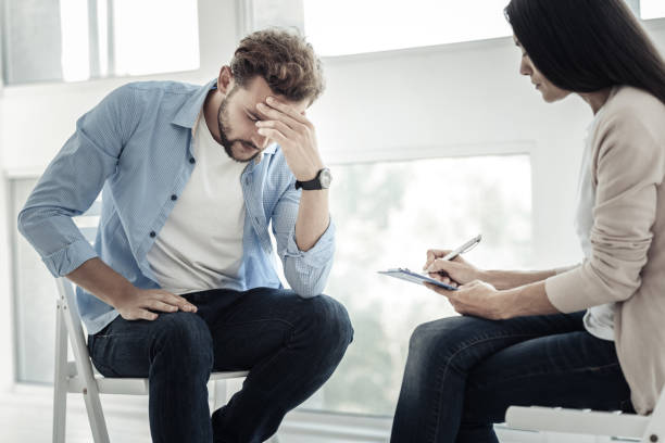 istock Sad depressed man holding his head 942567834