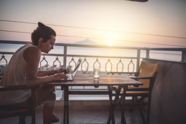istock Woman working with laptop at summer vacation 942570710