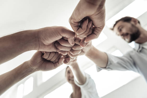 istock Low angle of fists held together 942571648