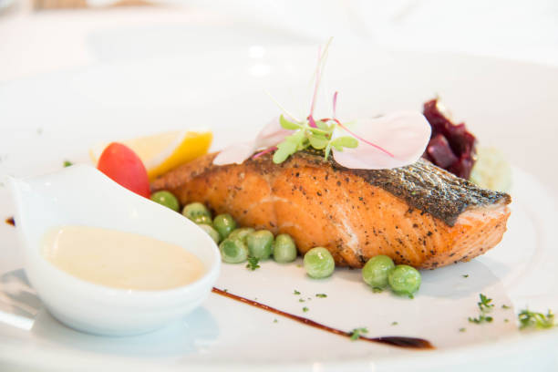 istock Tasty grilled salmon steak on mixed colorful vegetables 942572946