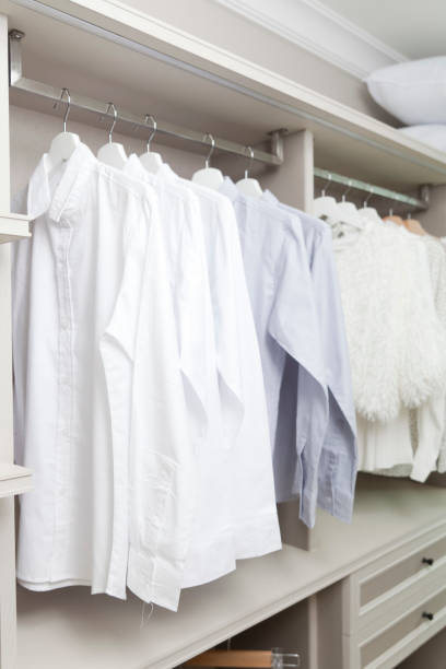 istock shirts hanging on hangers in closet 942578640