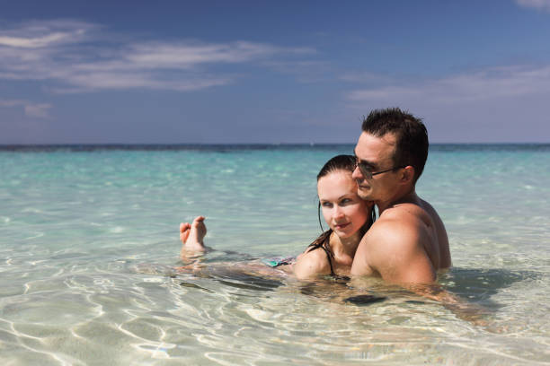istock man and woman on the beach 942580652