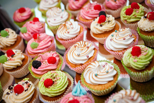 istock Tasty cupcakes on a white wooden table 942581004