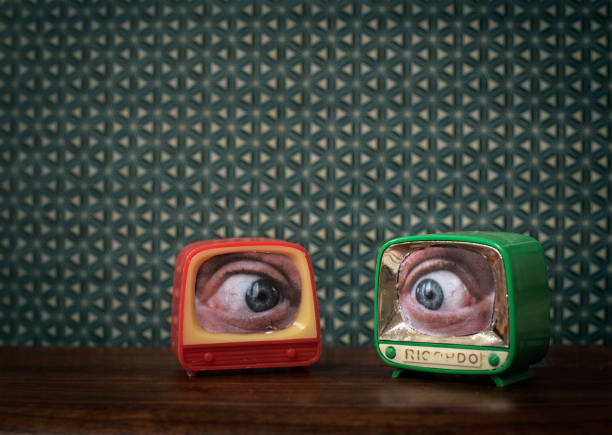 Watching TV Small TV´s eyes watching slapstick comedy stock pictures, royalty-free photos & images