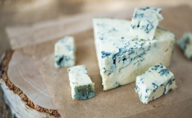 istock Blue cheese dorbly on parchment paper in the kitchen close up 942584592
