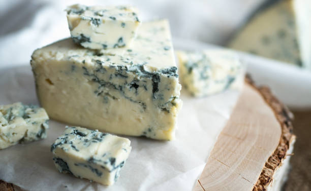 istock Blue cheese dorbly on parchment paper in the kitchen close up 942584626