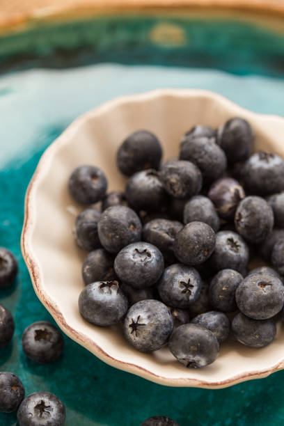 istock Healthy eating. Blueberries in small  white ceramice plate 942585194