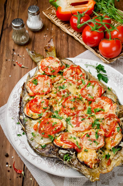 istock Grilled fish with vegetables and cheese 942594624