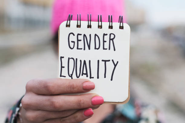 istock woman with a pink hat and the text gender equality 942595642