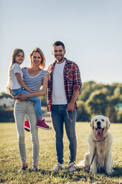 istock Happy family with dog 942596540