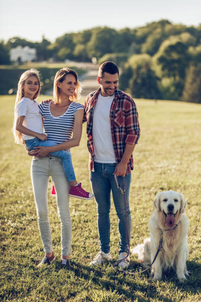 istock Happy family with dog 942596658