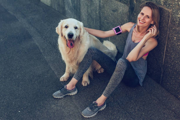 istock Woman running with dog 942598904