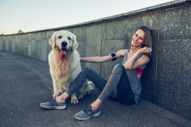 istock Woman running with dog 942598906