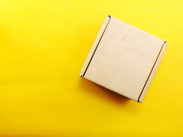 istock top view of paper box on yellow background 942599170