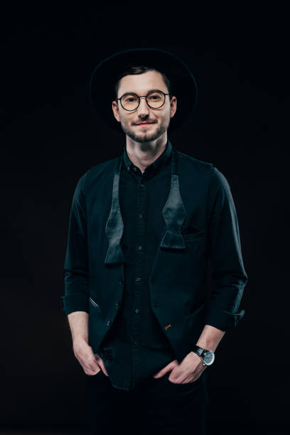 istock Young stylish man in black clothes isolated on black 942603068