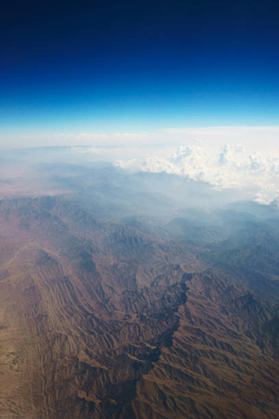 Aerial view at mountain range from airplane above Afghanistan. Geological surface structures of planet earth. Horizon over land. No people. XXXL (Sony Alpha 7R)