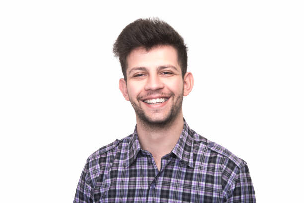 istock Portrait of laughing young man looking at camera on white background 942603544