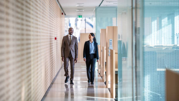 Business colleagues walking in office