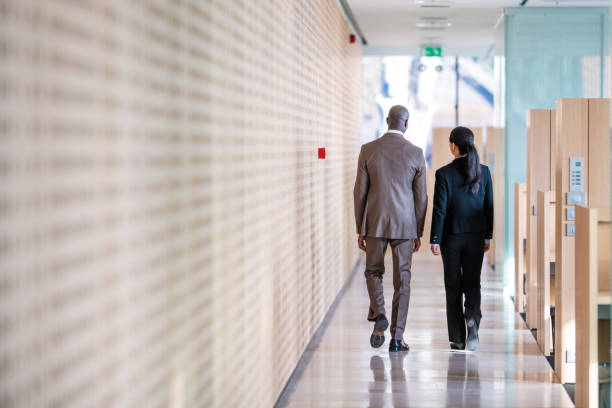 istock Business colleagues walking in office 942603988