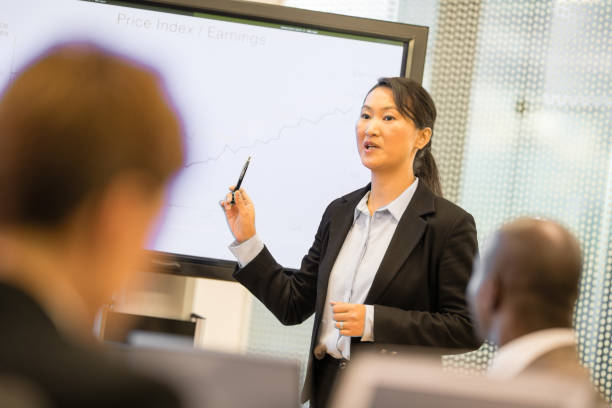 istock Businesswoman explaining graph to businessmen 942604008