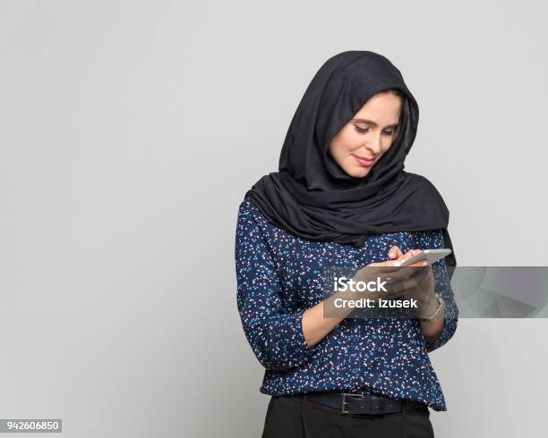 Cheerful Young Muslim Woman Using Smart Phone Stock Photo - Download Image Now - 20-29 Years, Adult, Adults Only