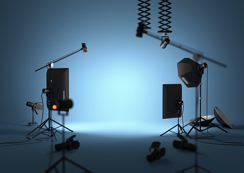 An empty blue photography studio with lighting equipment. 3D illustration