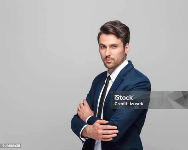 Portrait Of Elegant Young Man In Suit Stock Photo - Download Image Now - Men, Portrait, Arms Crossed
