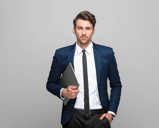 istock Confident and handsome businessman holding laptop 942608596